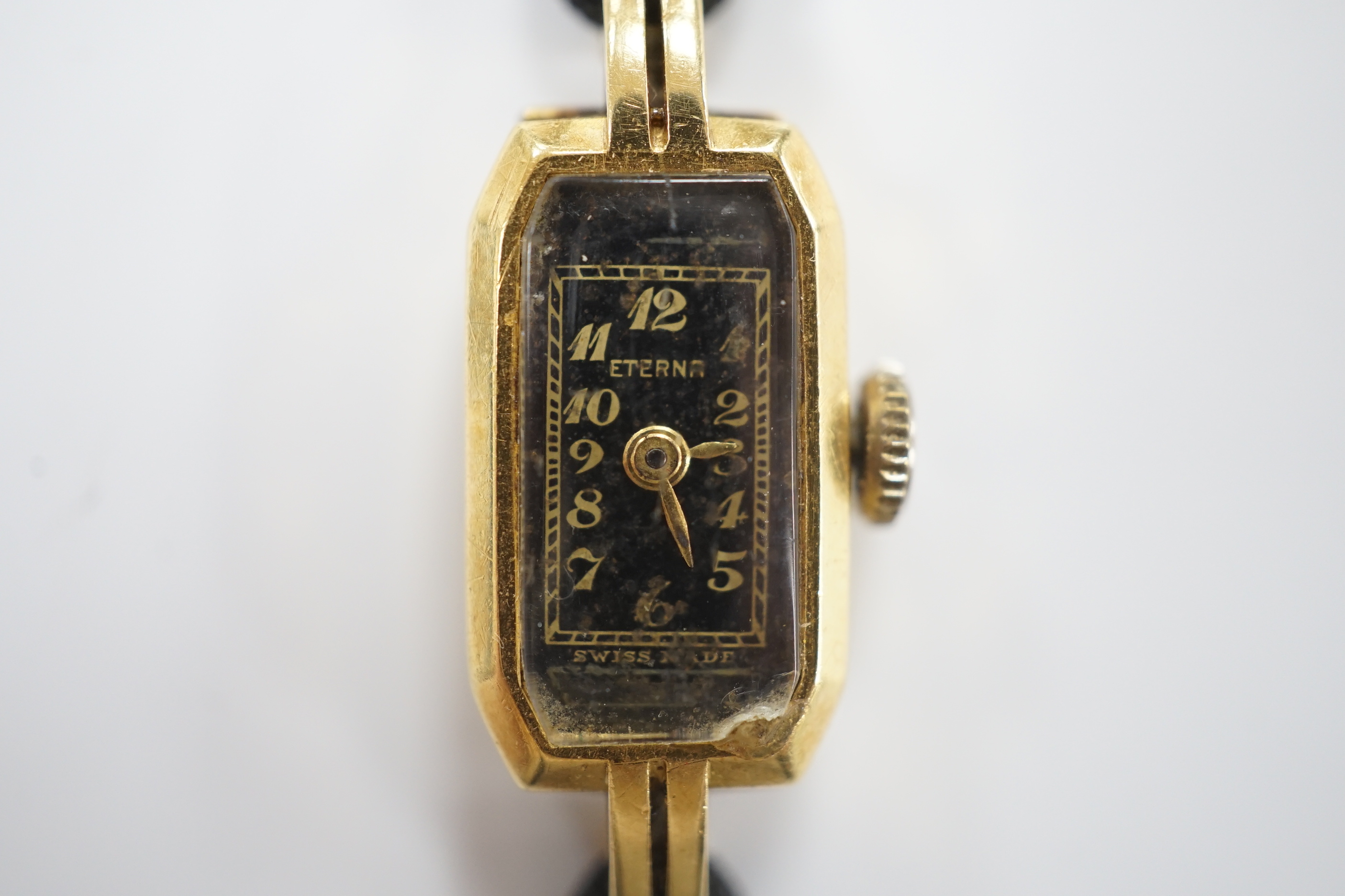 A lady's 1930's 18ct gold Eterna manual wind wrist watch, on a twin strand fabric strap with gold plated clasp